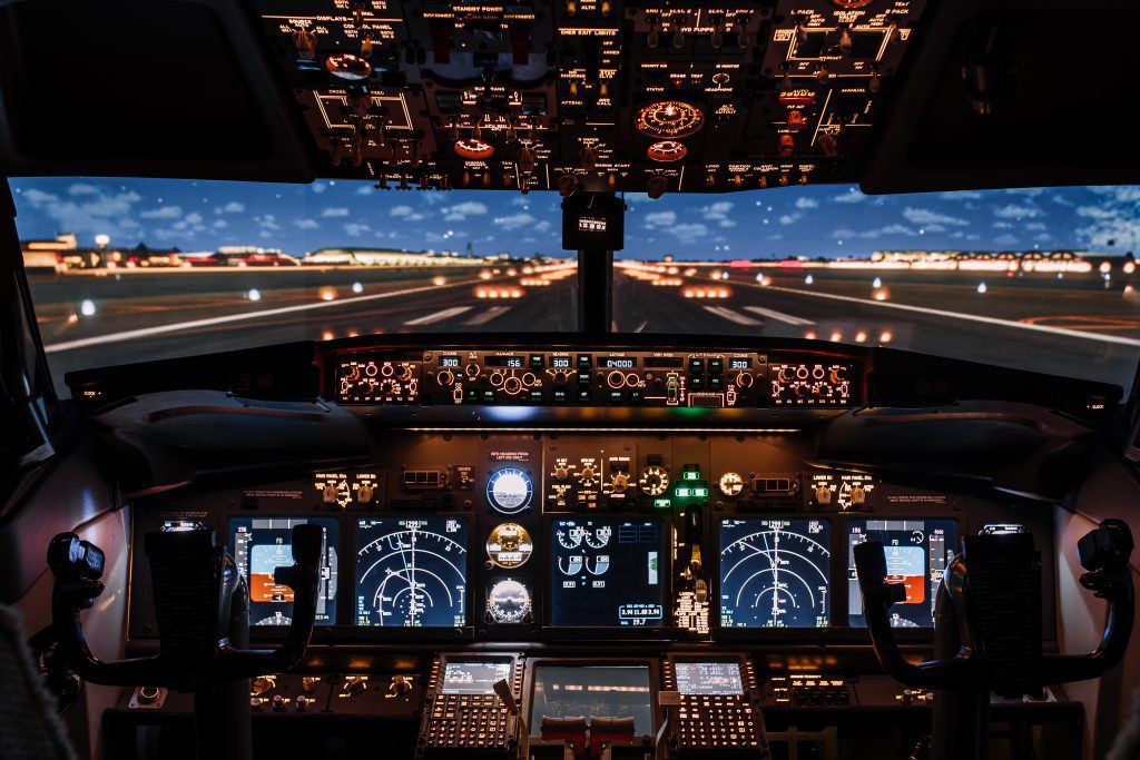 Dramatic Full view of cockpit modern Boeing aircraft before take-off. Airplane is ready to fly. Night shot in cabin. Safety flight